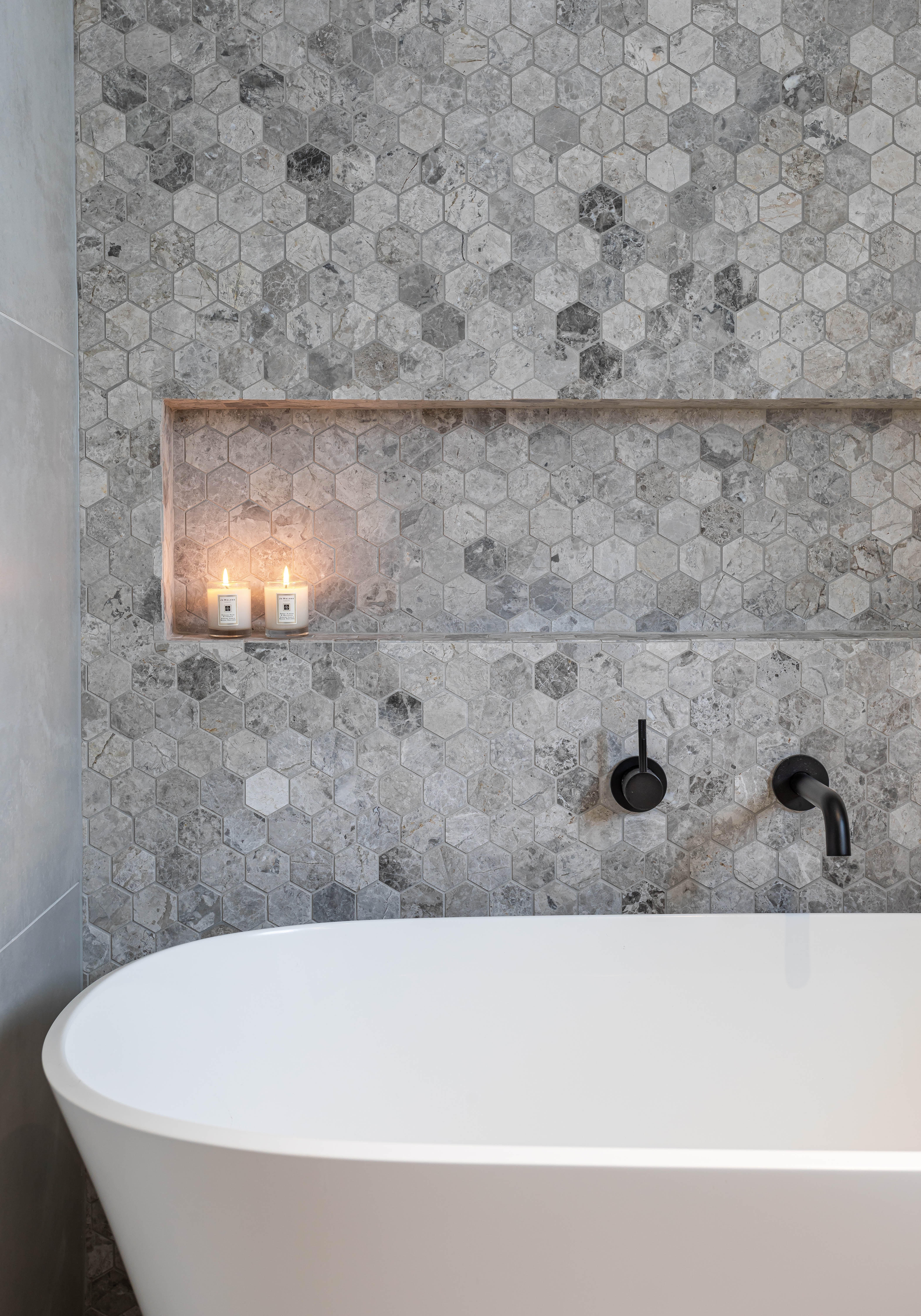 Bathtub in tiled bathroom