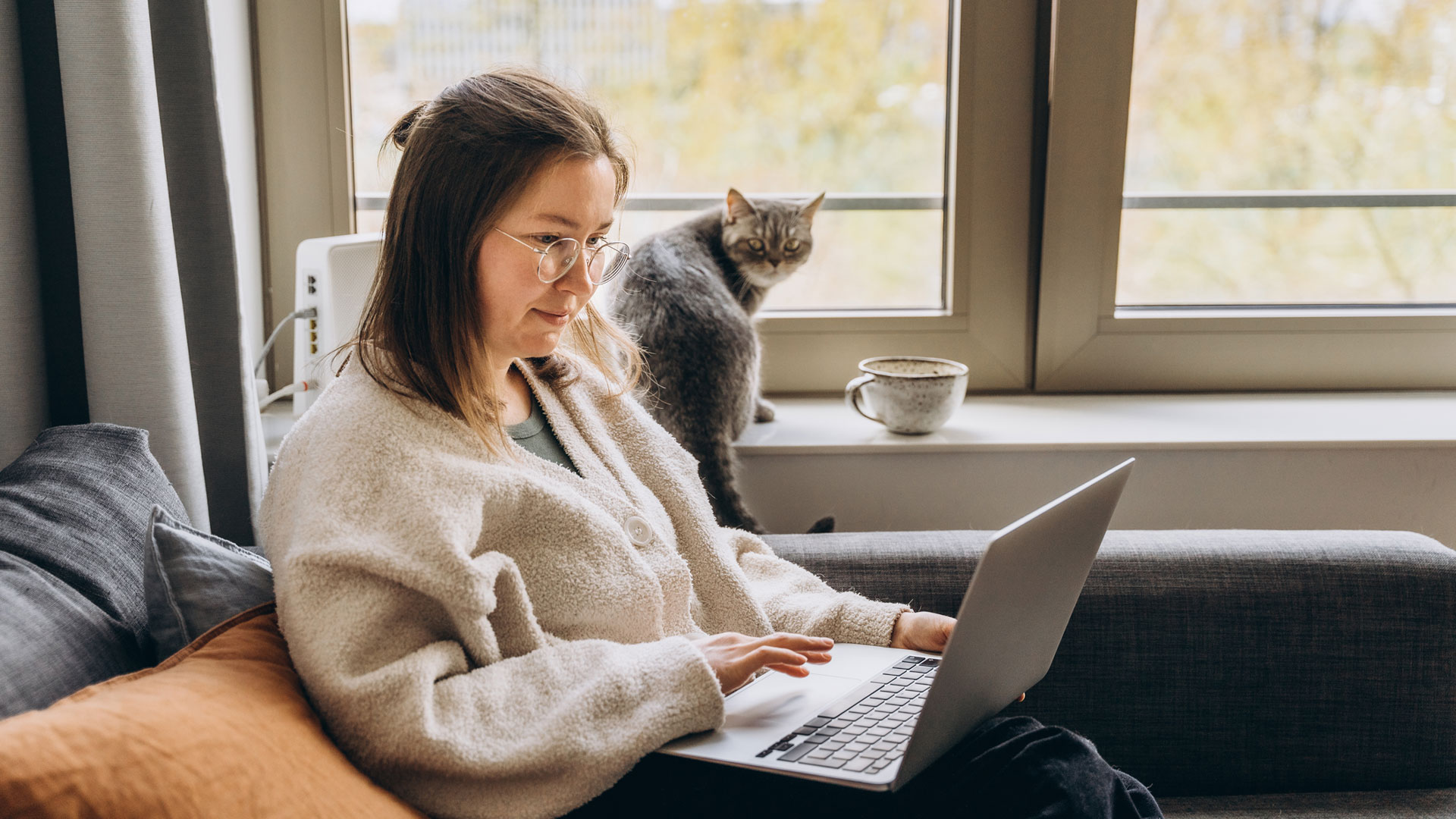 Woman researching the value of homes on her laptop at home.