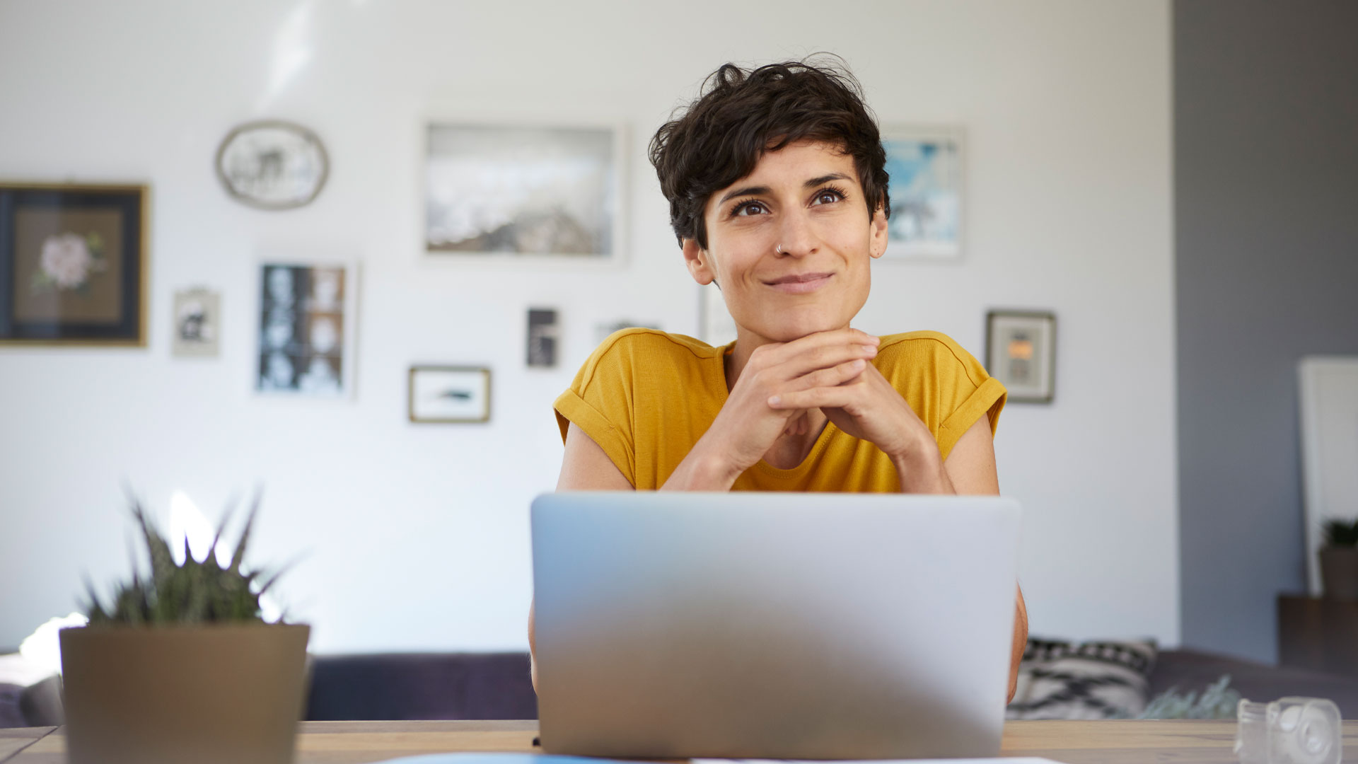 Woman sitting at her desk smiling.