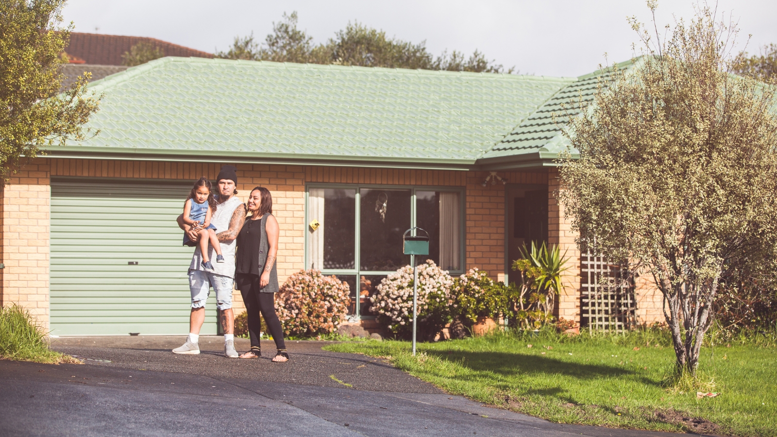 Family standed out in front of property.