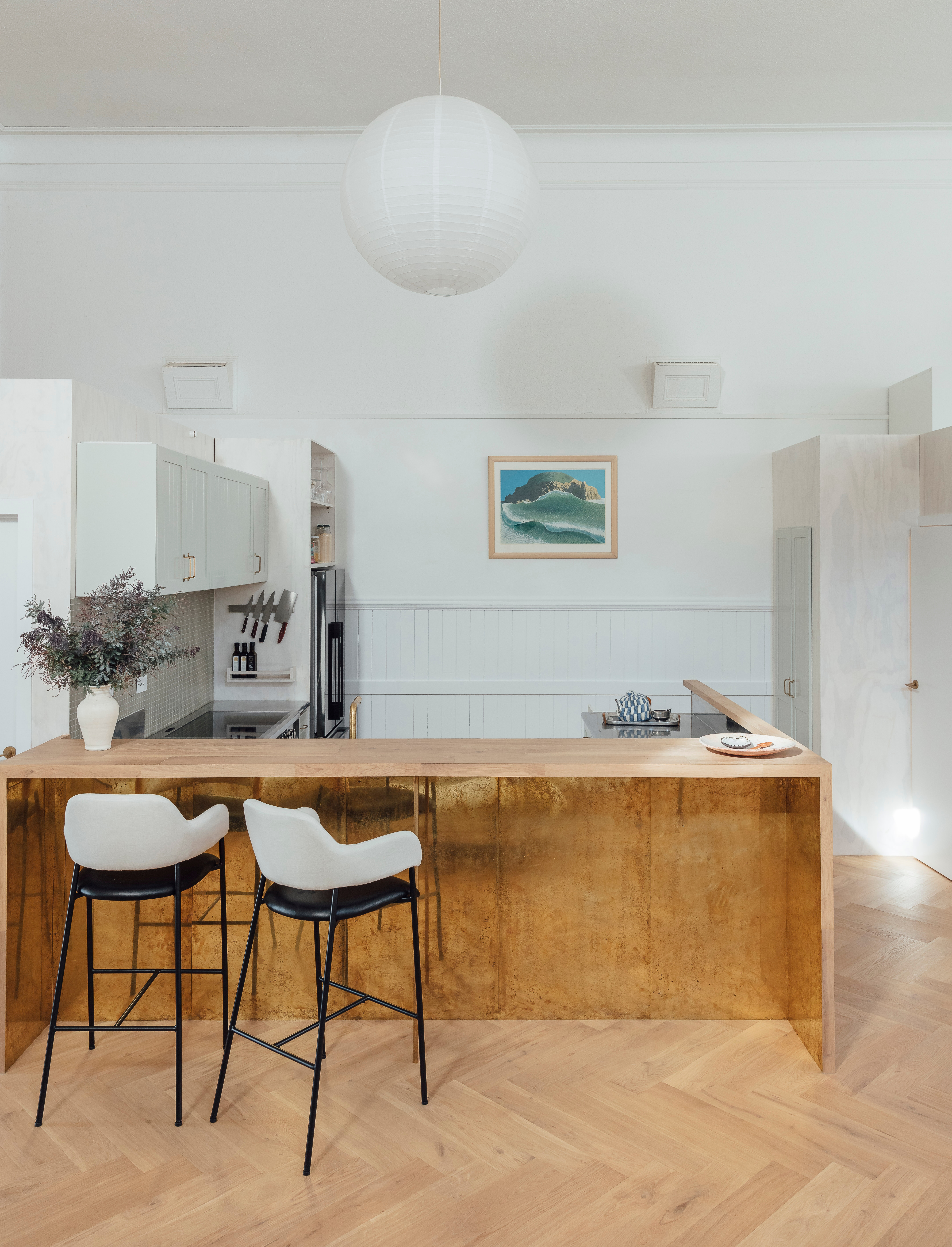 Surrounded by oak timber left over from the flooring, the kitchen island’s brass kickplate is made from another salvaged material; scored from a local bar, it would otherwise have been dumped. The artwork on the wall here is by Michael Smither.