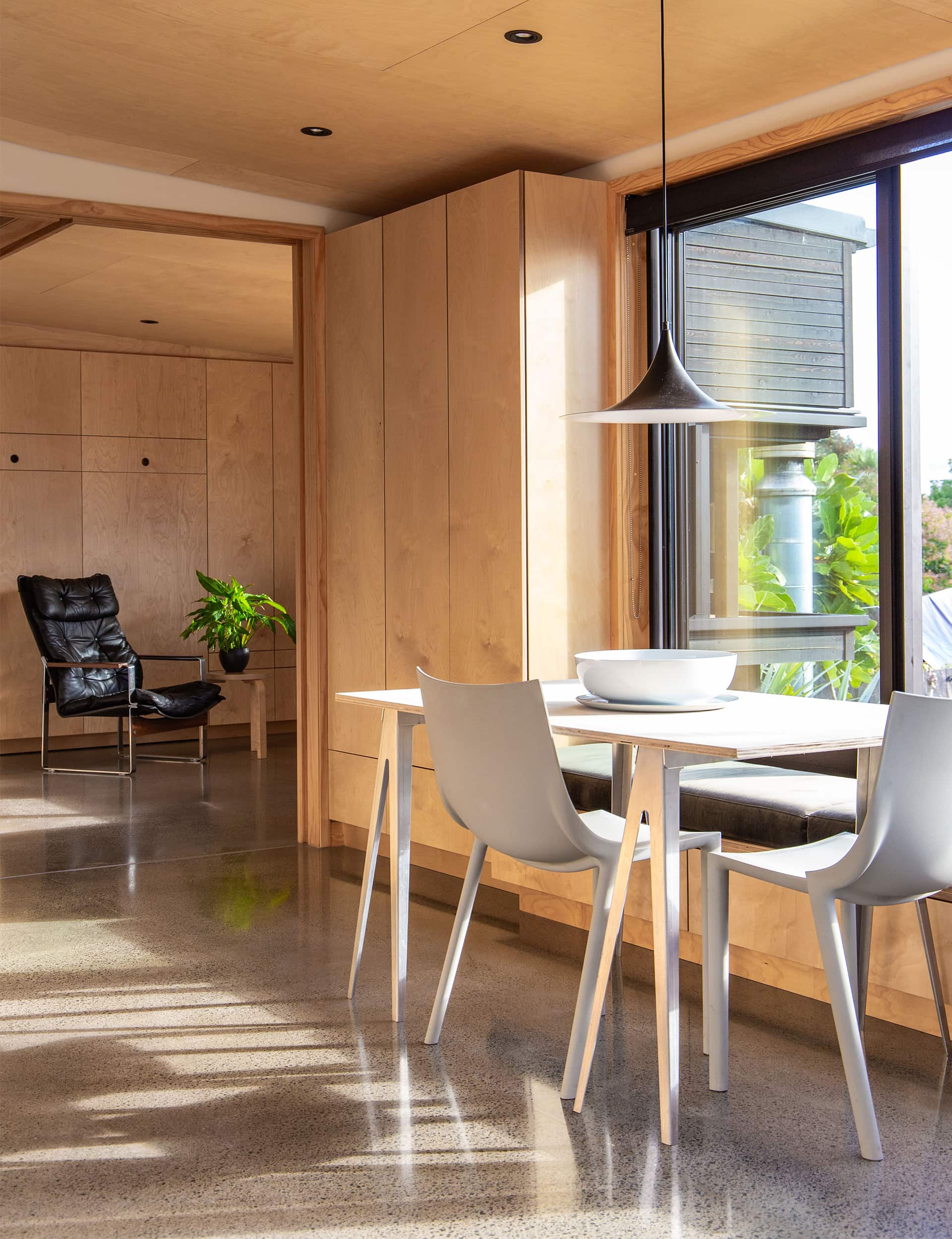 Contemporary open plan dining room with concrete floors