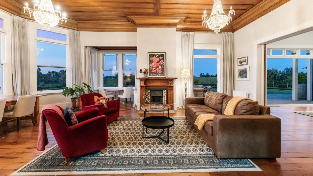 Oil stains remain on the floor of the formal living room from the days when the house was a mechanics’ workshop