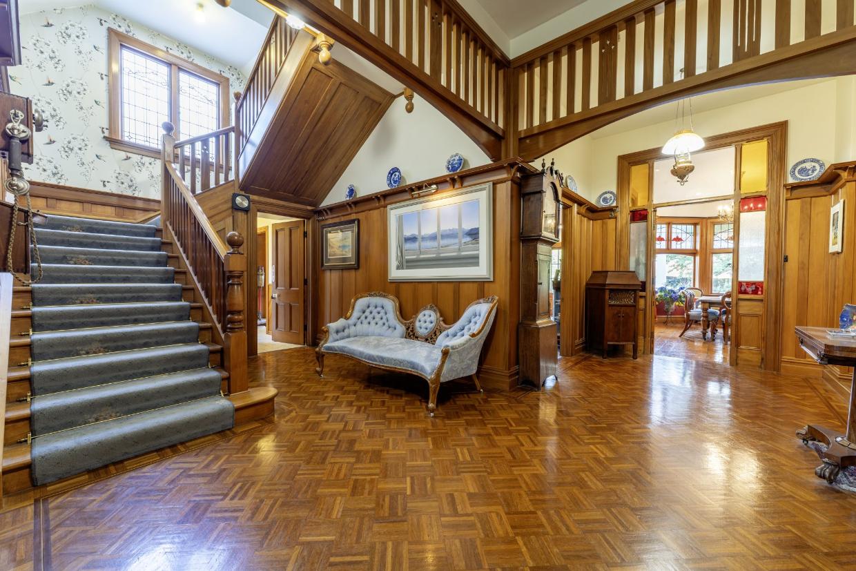 A grand staircase and parquet floor are key features of the entry. Photo: Harcourts