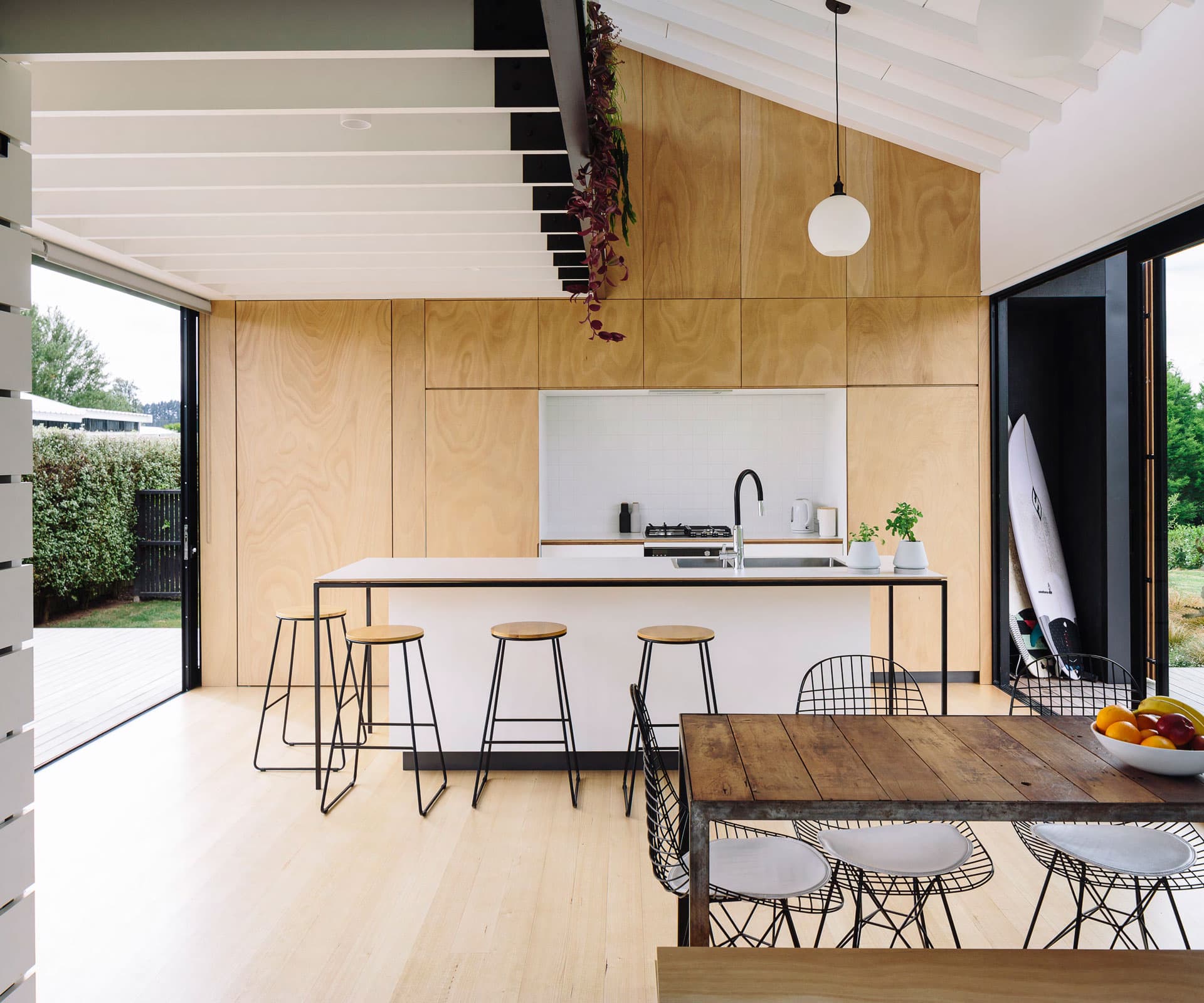 Open plan bright wooden kitchen with breakfast bar, industrial but open.