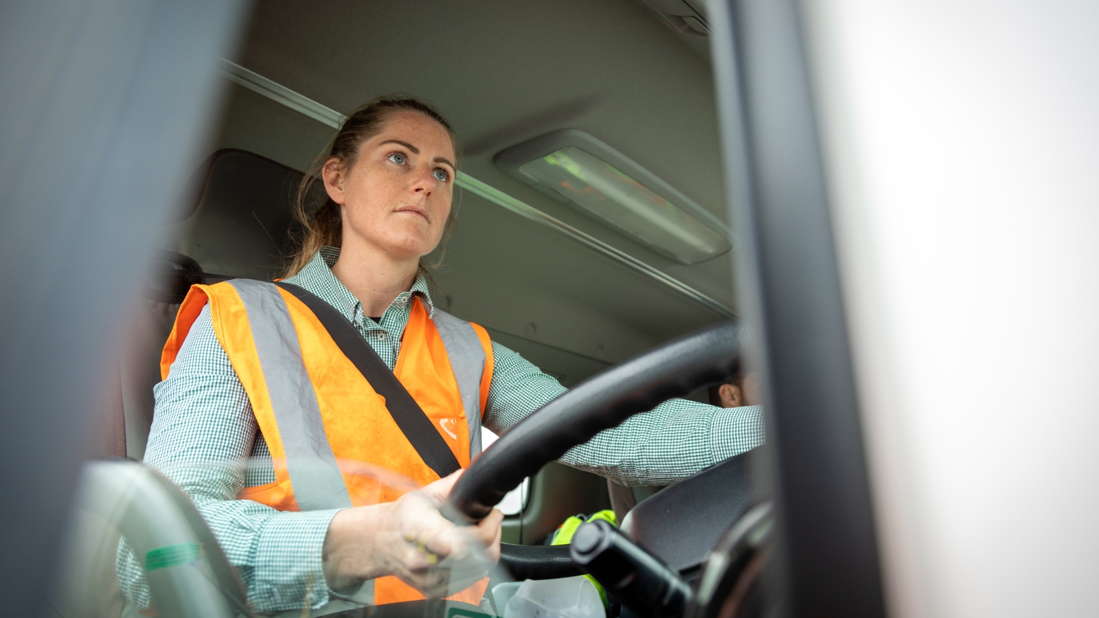 Female delivery driver in hi vis vest. 