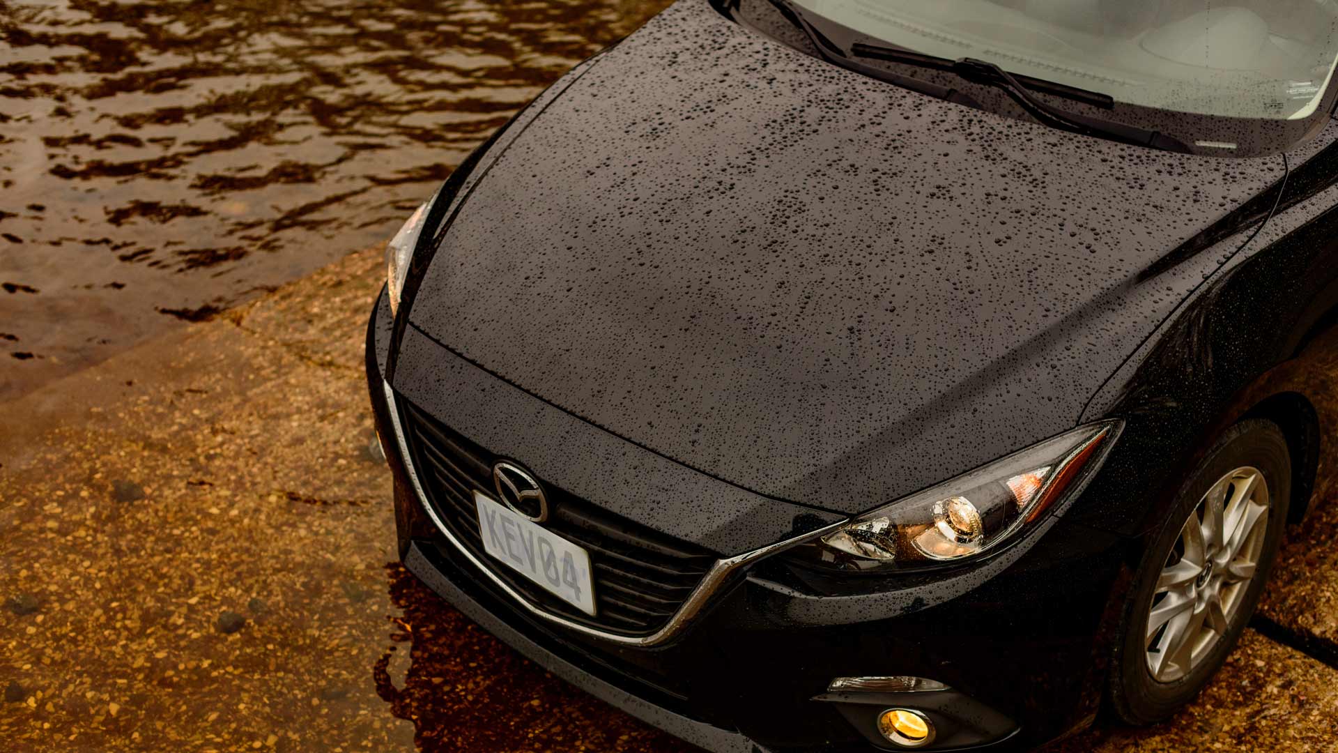 Small black car in rain