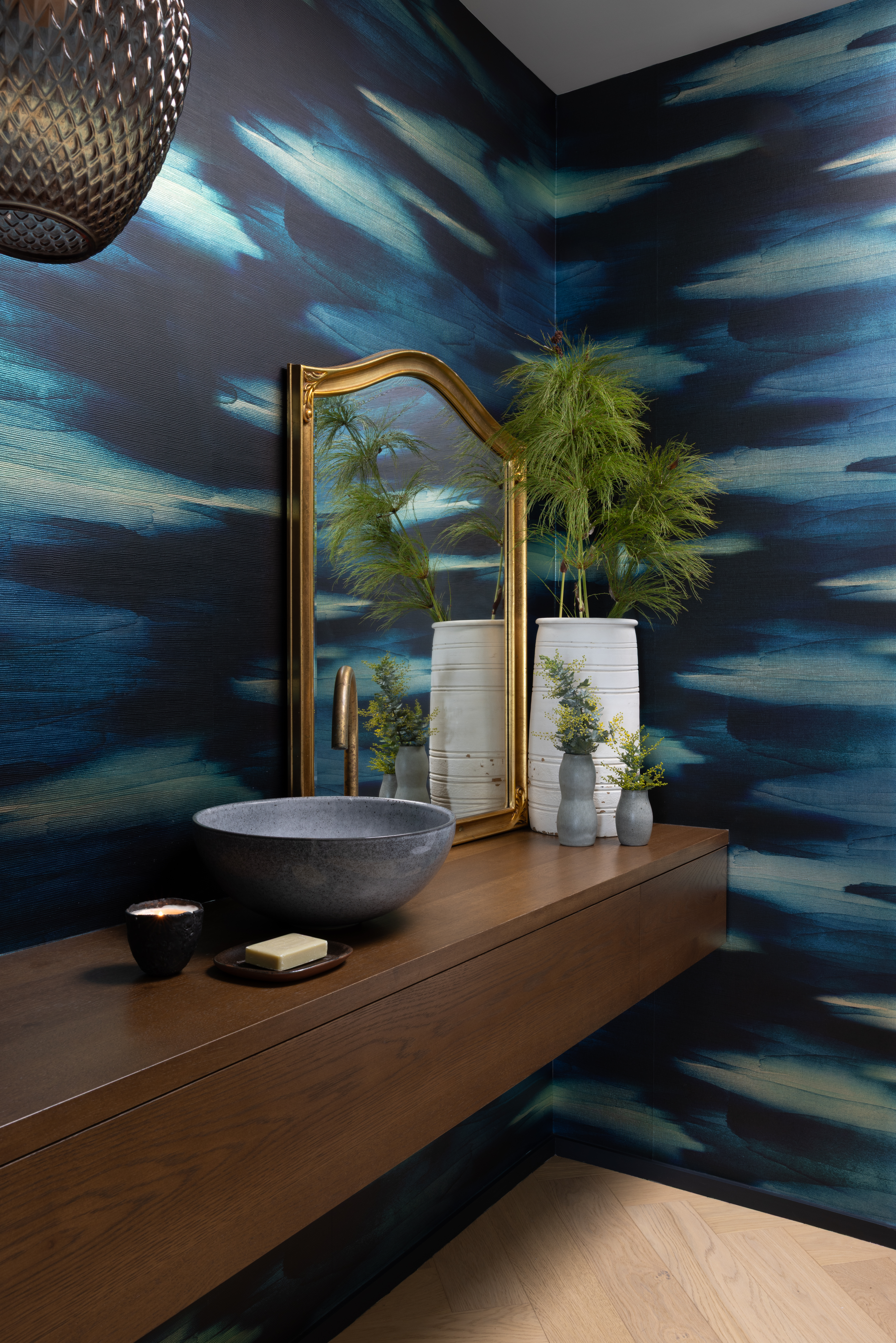 Unique wallpaper and vintage design in the powder room. 
