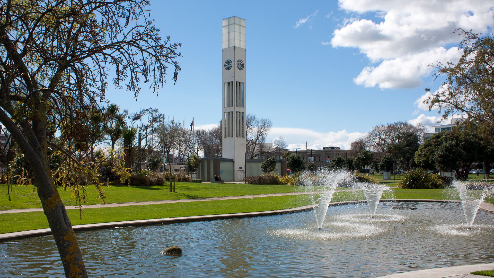 A photo of central Palmerston North, showing a fountain and a clock tower.