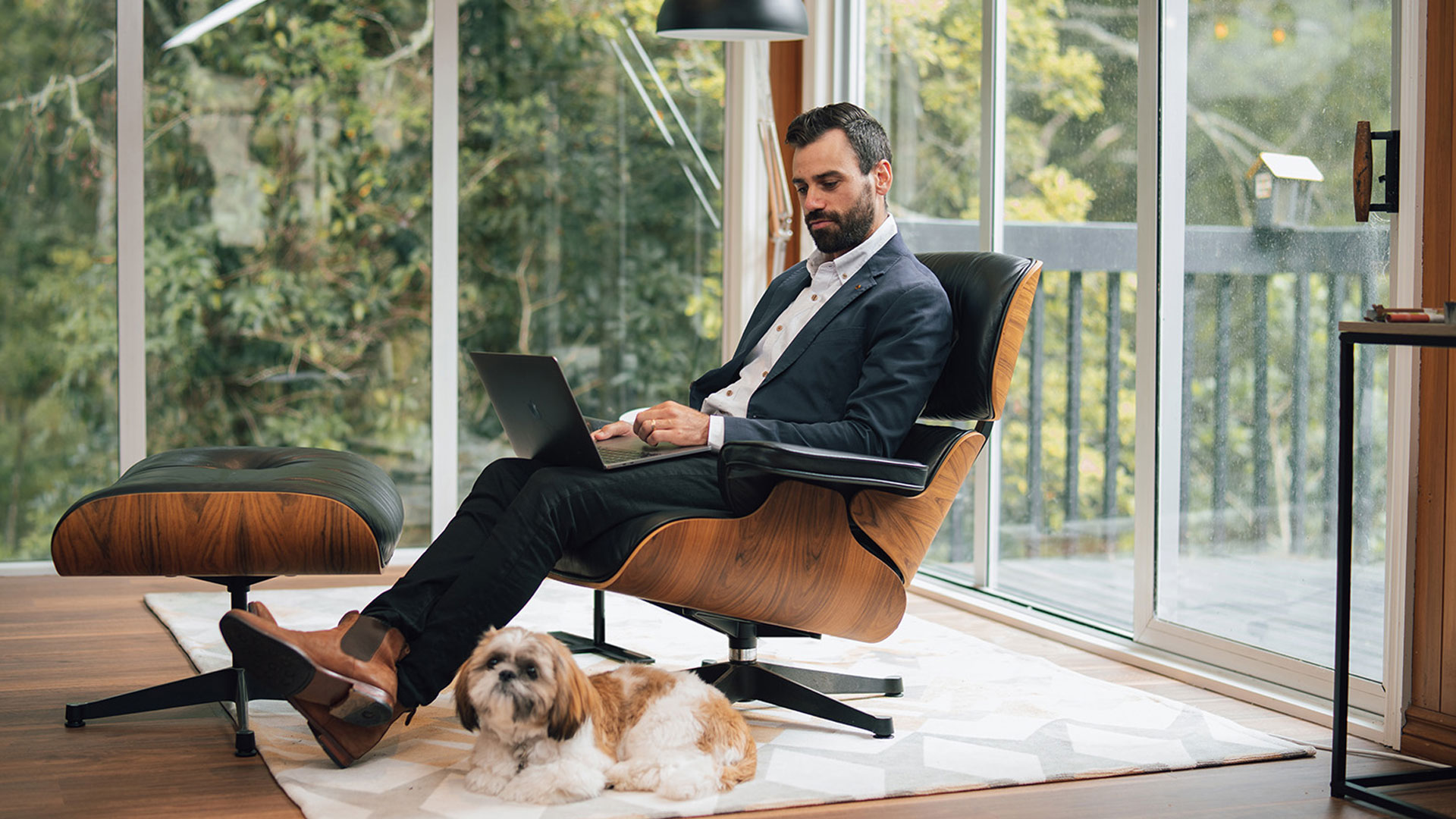 Man in a suit preparing for a job interview on his laptop at home.