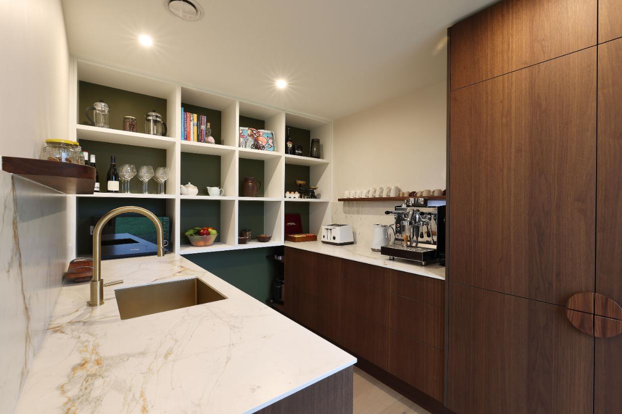 The scullery is at the end of the kitchen.