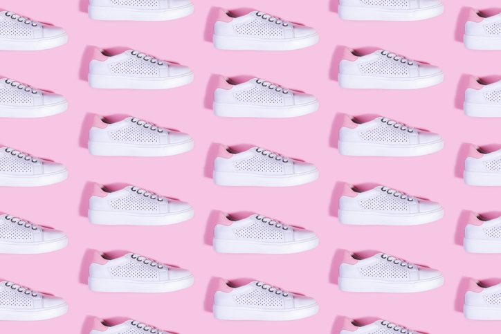 white sneakers on pink background