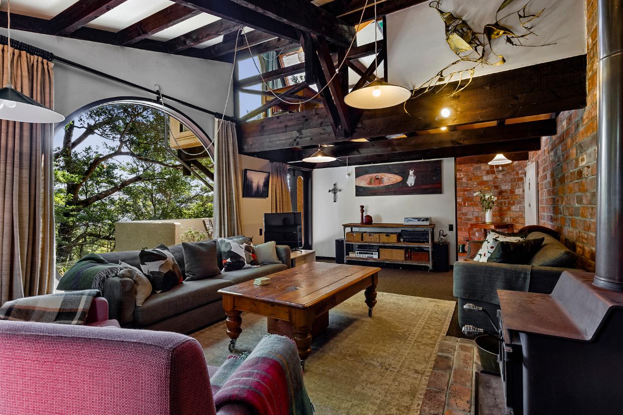 The downstairs living room is a cosy corner of the house, with an incredible view. 