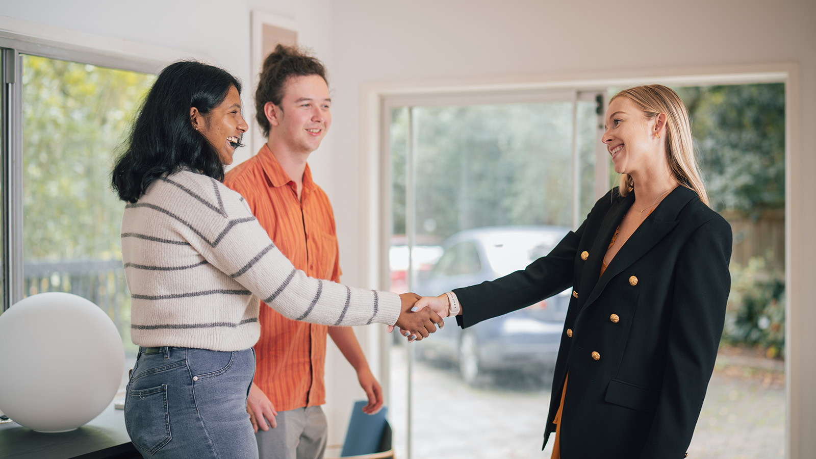 Property manager shaking tenant's hand. 