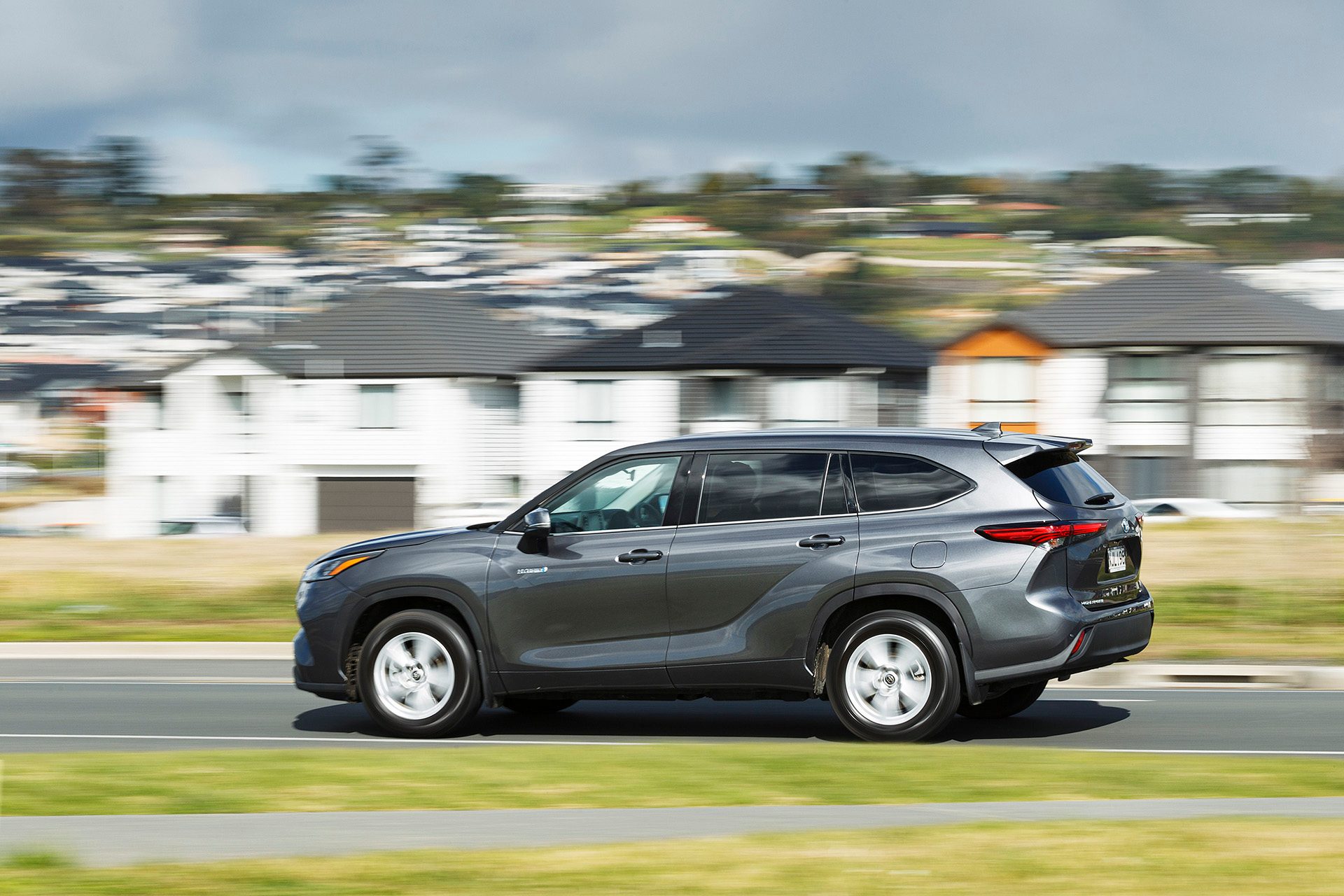 Dark Grey Toyota Highlander driving side view