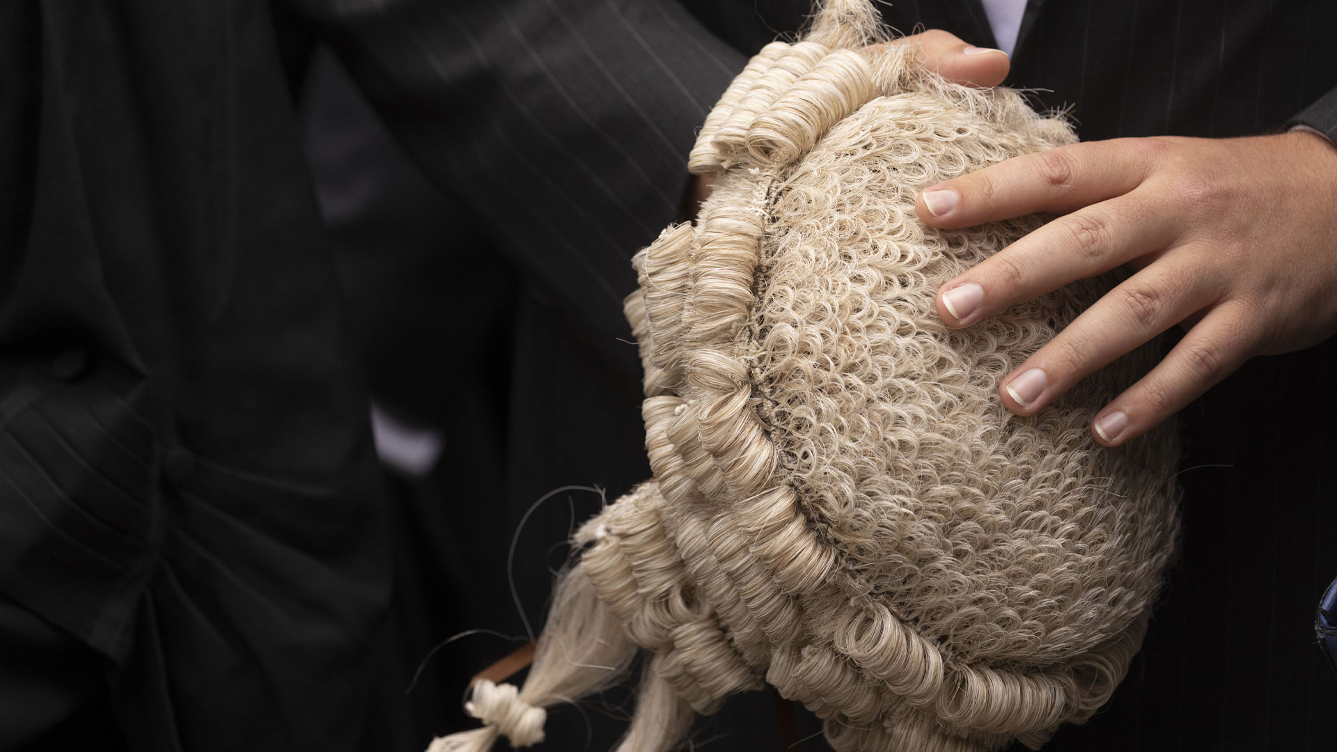 Solicitor holding a wig at their bad admission ceremony.