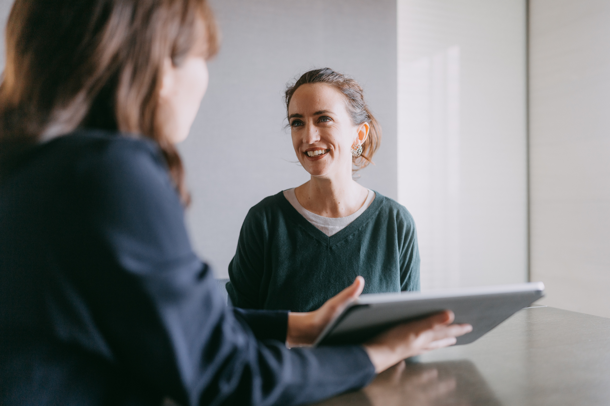 A woman meeting with a family lawyer for advice on relationship property and legal rights in New Zealand.