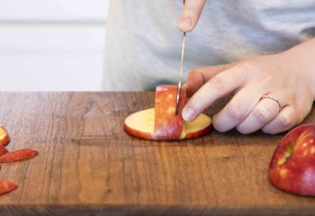 Cutting a slice out of the top side of the apple