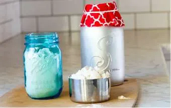 two recipe jars with a measuring cup sitting on a cutting board on the counter