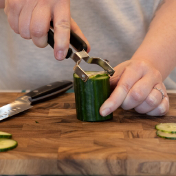 Image  of a cucumber having the peeling removed using the peeler