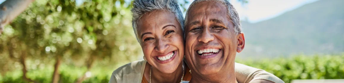 Elderly couple smiling outside