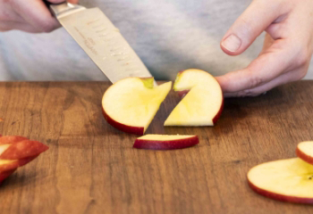 Apple half the heart shape facing away from the person with a cut in the apple that looks like a backwards Z