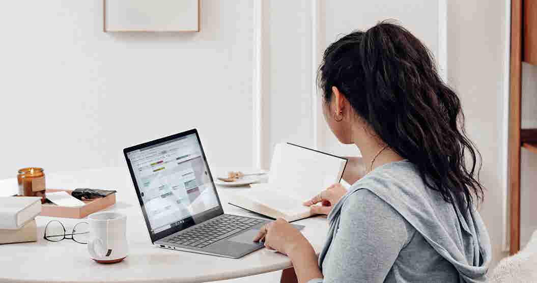 Woman using her computer to research zero-based -budgeting examples