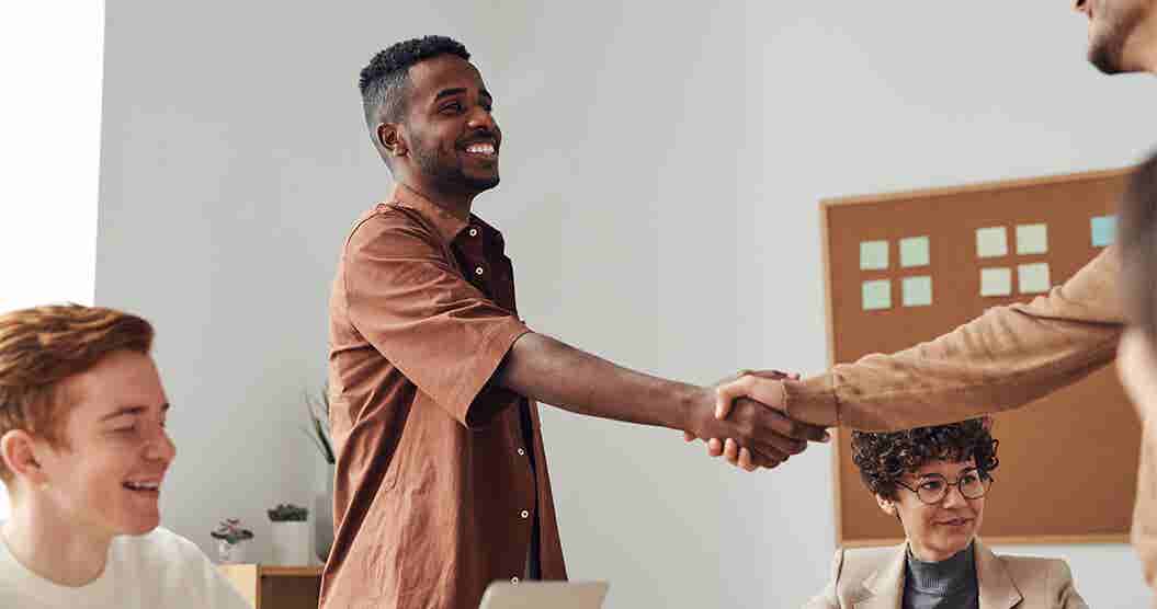 Young man shaking hands after a successful job interview.