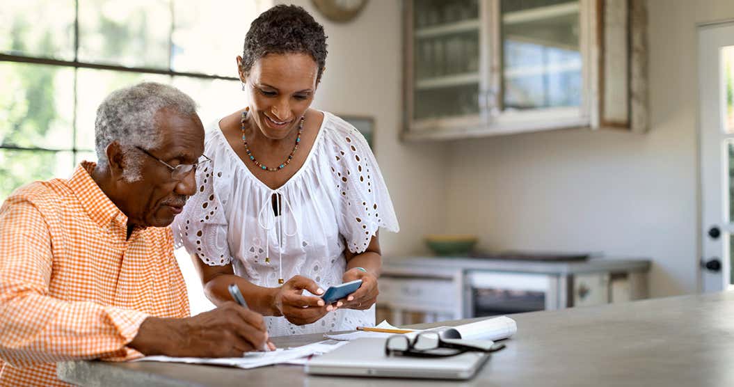 Elderly couple at home learning about installment loans