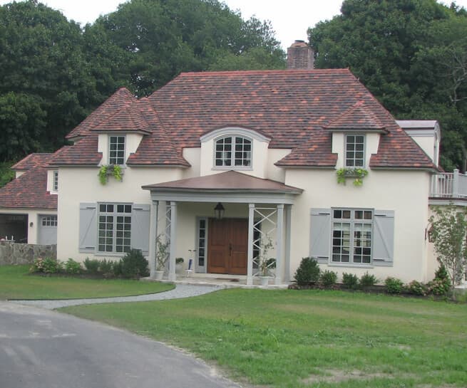 Front exterior view of Provencal-style home with new wood windows and doors
