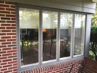 Casement windows on red brick home before replacement