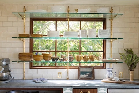 Glass shelving in front of window