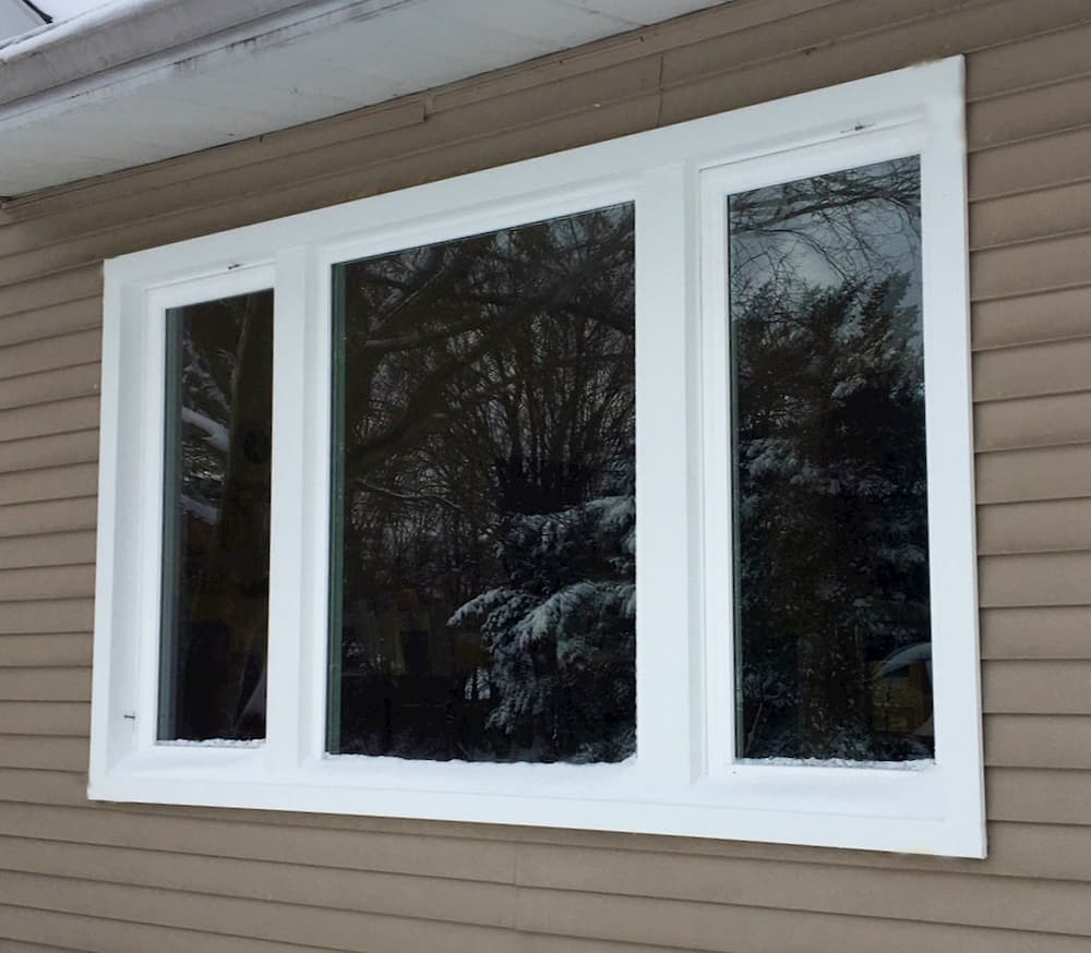 Exterior view of new white vinyl casement windows