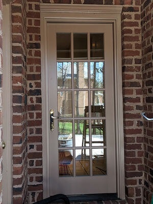 hinged patio door on brick home