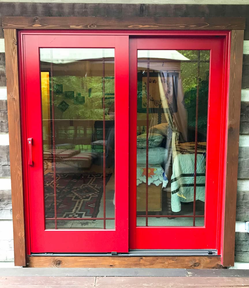 Exterior view of wood sliding patio door with a cherry red finish