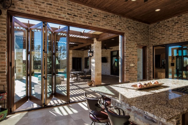 A stunning exterior bi-fold patio door combines indoor and outdoor spaces seamlessly