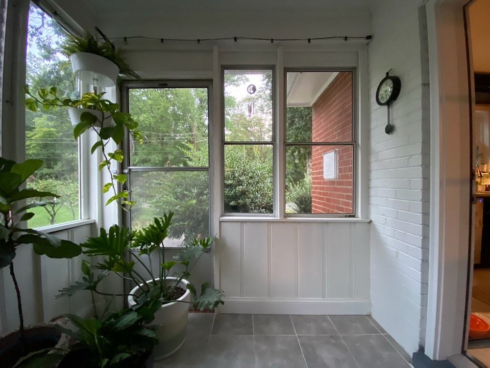 Updated enclosed porch in Richmond, VA, with white vinyl double hung windows