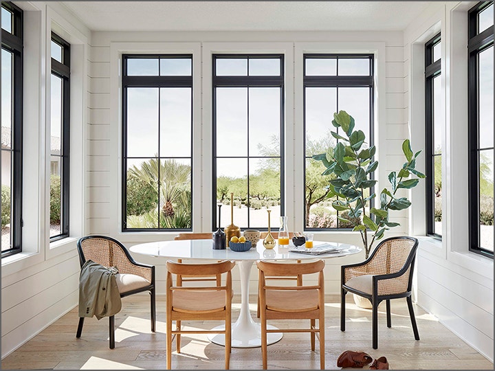 A picture of a dining room with windows