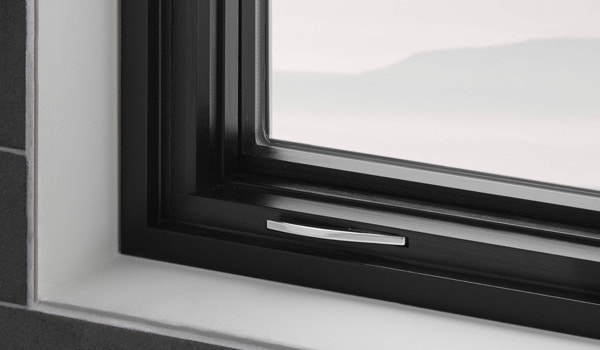 Casement window corner view with black interior trim and fold-away crank