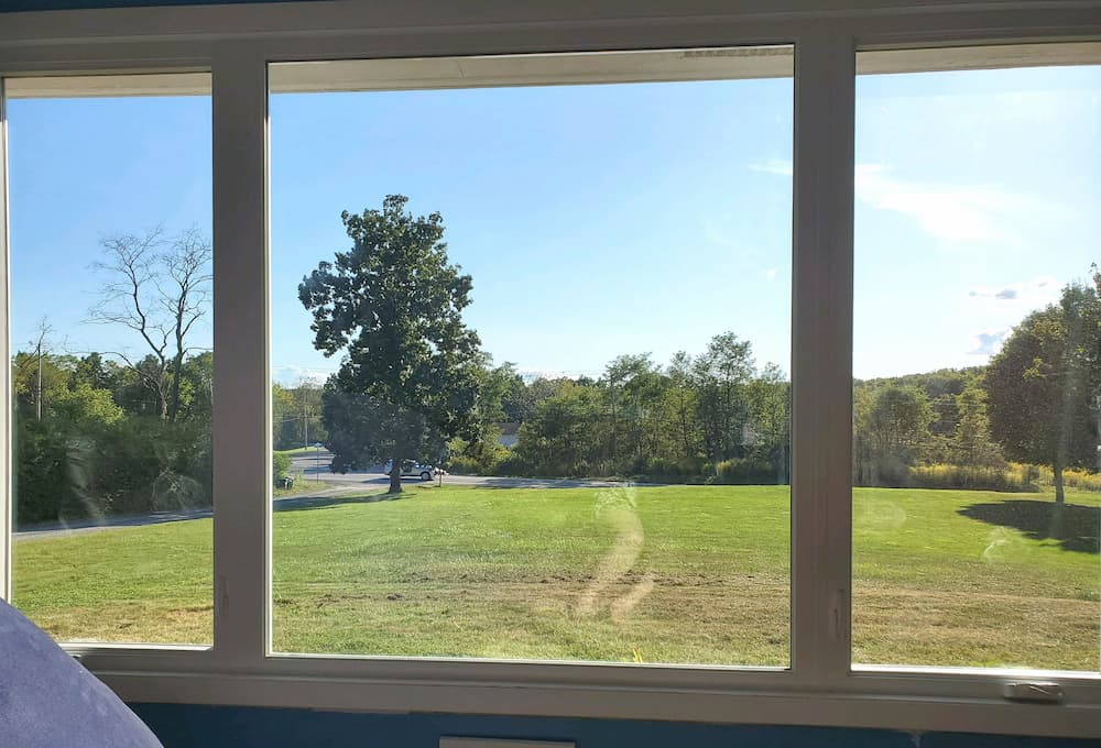 Interior view of vinyl casement windows overlooking a green yard