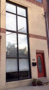 Old commercial windows and red entry door