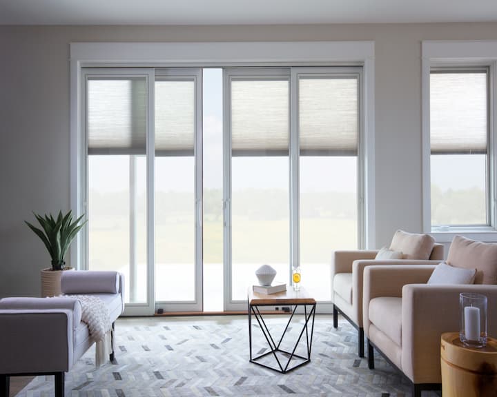 Pella vinyl sliding glass doors with shades between the glass in the living room