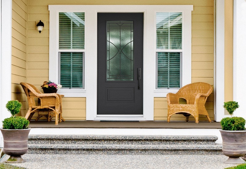 Front entry door with yellow siding