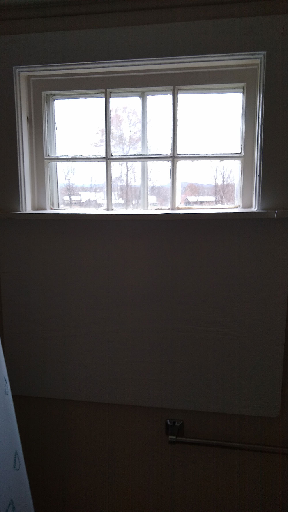 Old bathroom window in Century home in Hadley, MA, before upgrade to vinyl windows