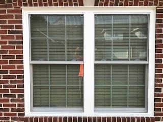 New white vinyl double-hung windows with traditional grille patterns