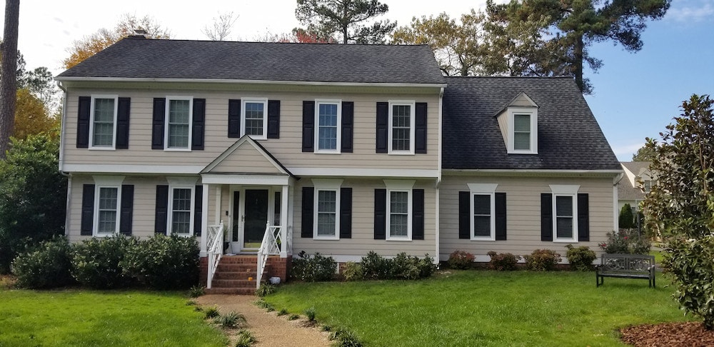 Exterior of Henrico, VA, home with new white vinyl double-hung windows