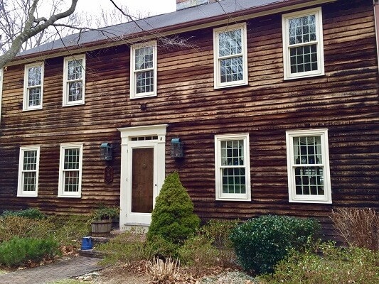 street view of Hartford colonial home featuring new white wood windows from Pella 