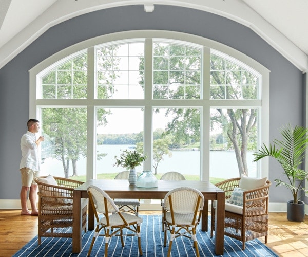 Large, wall-sized curved white window overlooking a lake view