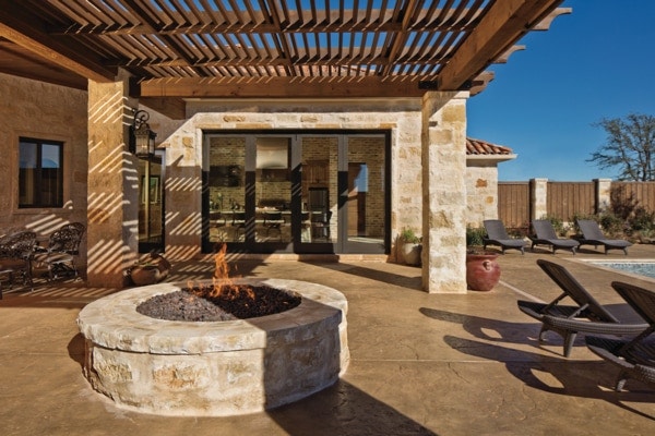 covered patio area featuring a fire pit and natural tones