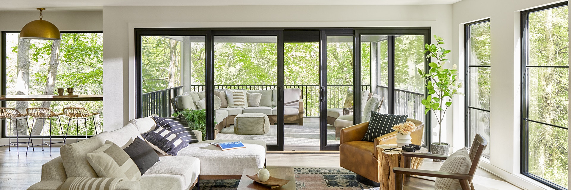Floor To ceiling windows and patio doors open home to backyard/